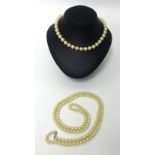 Cultured pearl necklace made of 8 strings of small button shaped pearls. Two faux pearl necklaces