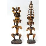 A pair of carved wood Eastern tribal figures, tallest 61cm.