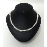 2 strings of white pearls.1 string round cultured pearls with and 18K clasp (set with a single