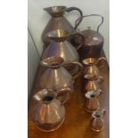Eight 19th century copper haystack measures, graduated also a large copper kettle (9)