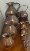 Eight 19th century copper haystack measures, graduated also a large copper kettle (9)