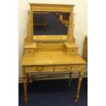 A pine dressing table with fluted legs and white china casters.