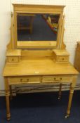 A pine dressing table with fluted legs and white china casters.