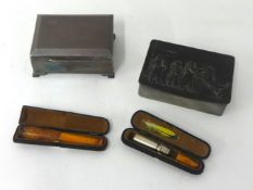 Silver cigarette box, pewter box and two cased amber cheroot holders