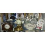 Light oak plant stand, clocks and two decanters.