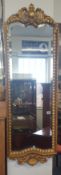 A reproduction ornate gilt frame hall mirror, height 136cm, width 45cm.