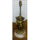 A gilt metal heavy table lamp in the form of three putti on marble socle base, height 38cm