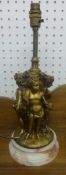 A gilt metal heavy table lamp in the form of three putti on marble socle base, height 38cm