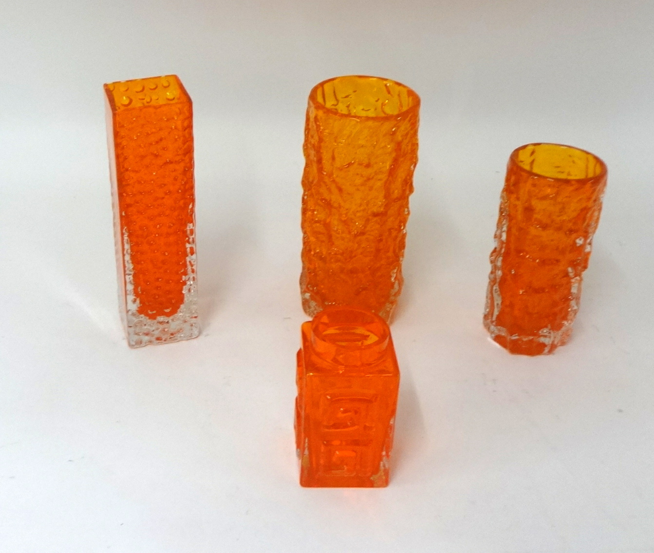 Four orange Whitefriars glass vases.