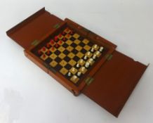 A carved bone antique travelling chess set.