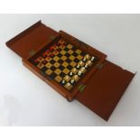 A carved bone antique travelling chess set.