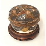 Japanese earthenware Satsuma box and cover, with carved wood stand.