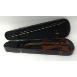 Cased violin and bow, with 'Stradivarius' paper label.