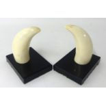 Two 19th century whales teeth mounted on wood stands