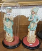 A pair of German bisque figures (one with a glass dome).
