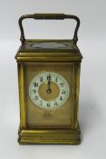 A brass carriage clock, the dial inscribed 'C.H.Cornish, Plymouth'.