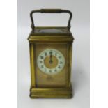 A brass carriage clock, the dial inscribed 'C.H.Cornish, Plymouth'.