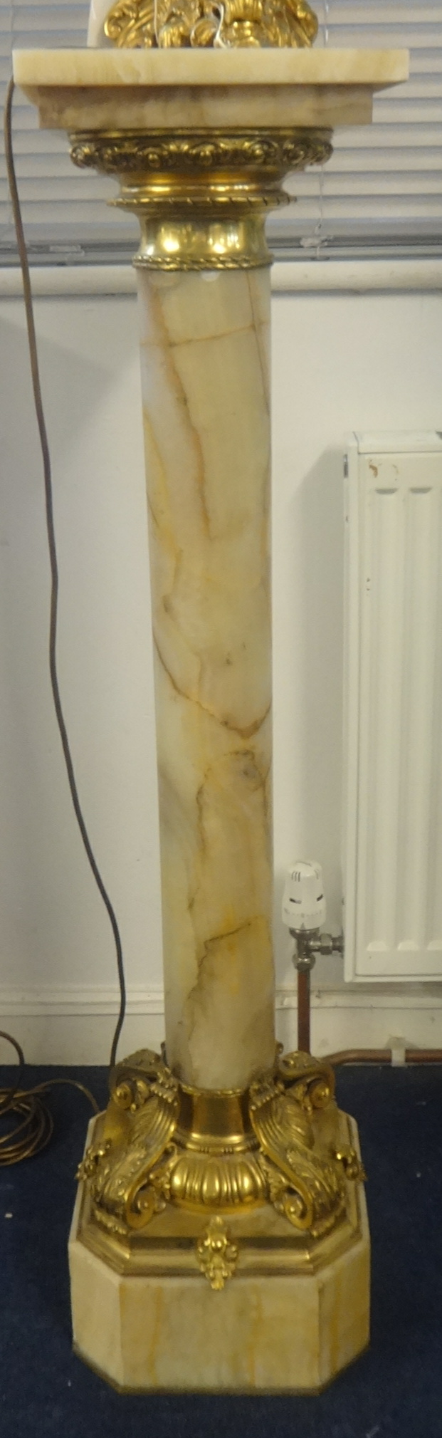 A marble column of French style with ormolu gilt decoration, height 109cm.