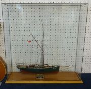 A scale model ship 'The Ranger' in glazed cabinet.
