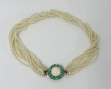 A turquoise and white coral necklace.