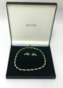 A Pravin's 18ct three colour gold collar and a pair of earrings, approx 36.30g.