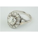 A fine diamond cluster ring, the centre old cut diamond approx 3.00 carats, set within a cluster