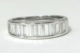 An 18ct white and diamond set half band eternity ring, set with baguette cut diamonds finger size