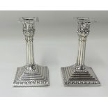 A pair of silver column candlesticks, height 15cm.