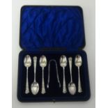 A Geo V seven piece silver set of pretty teaspoons and pair tongs in fitted case.