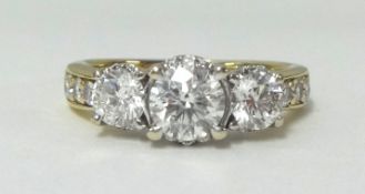 An 18ct diamond set ring, having three main stones, with a combined diamond weight of approx 2.25