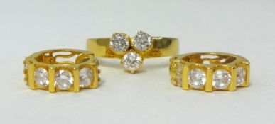 A 22ct gold ring set with three diamonds and a pair of similar earrings (3).