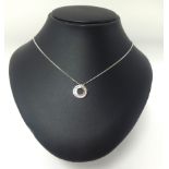 A white gold necklace set with small diamonds.