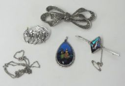 Three silver brooches and a silver pendant (4).