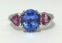 A tanzanite and pink sapphire 3 stone ring, finger size M/N.
