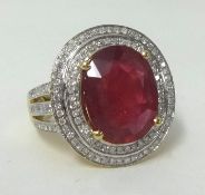 A 14k yellow gold and diamond ring set with an oval cut ruby, approx 7.00 carats, diamonds approx