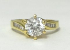An 18ct diamond set ring, with a centre stone approx 1.00 carat, and further baguettes to the