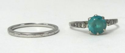 A platinum wedding band stamped H.S. Platinum, finger size L, 2.20 gms also a single stone blue