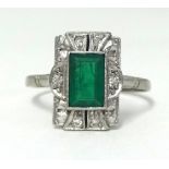 An 18ct yellow gold and platinum emerald and diamond set cluster ring, finger size O.