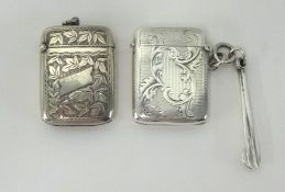 Two silver vestas with engraved decoration, also a silver pipe cleaner (3).