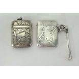 Two silver vestas with engraved decoration, also a silver pipe cleaner (3).