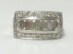 A white gold band ring, stamped .585, set with baguette and round cut diamonds, finger size O.