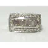 A white gold band ring, stamped .585, set with baguette and round cut diamonds, finger size O.