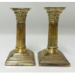 A pair silver column candlesticks.