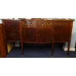 A large mahogany inlaid sideboard, on 6 square tapering legs on brass castors.