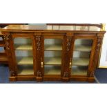 A Victorian figured walnut side cabinet, with three glazed doors.