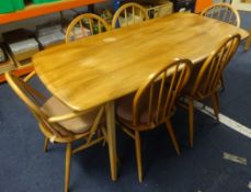 Ercol a light elm wood dining table and six chairs