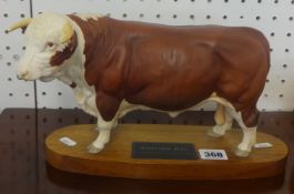 A Beswick Hereford Bull on wood plinth.