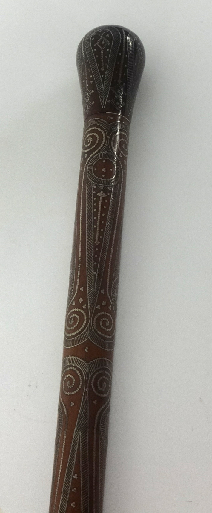 A hardwood walking cane with fine ornate white metal inlay