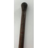 A hardwood walking cane with fine ornate white metal inlay