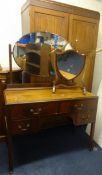 A mahogany two door wardrobe, a dressing table and a dressing table 'shield' mirror (3)